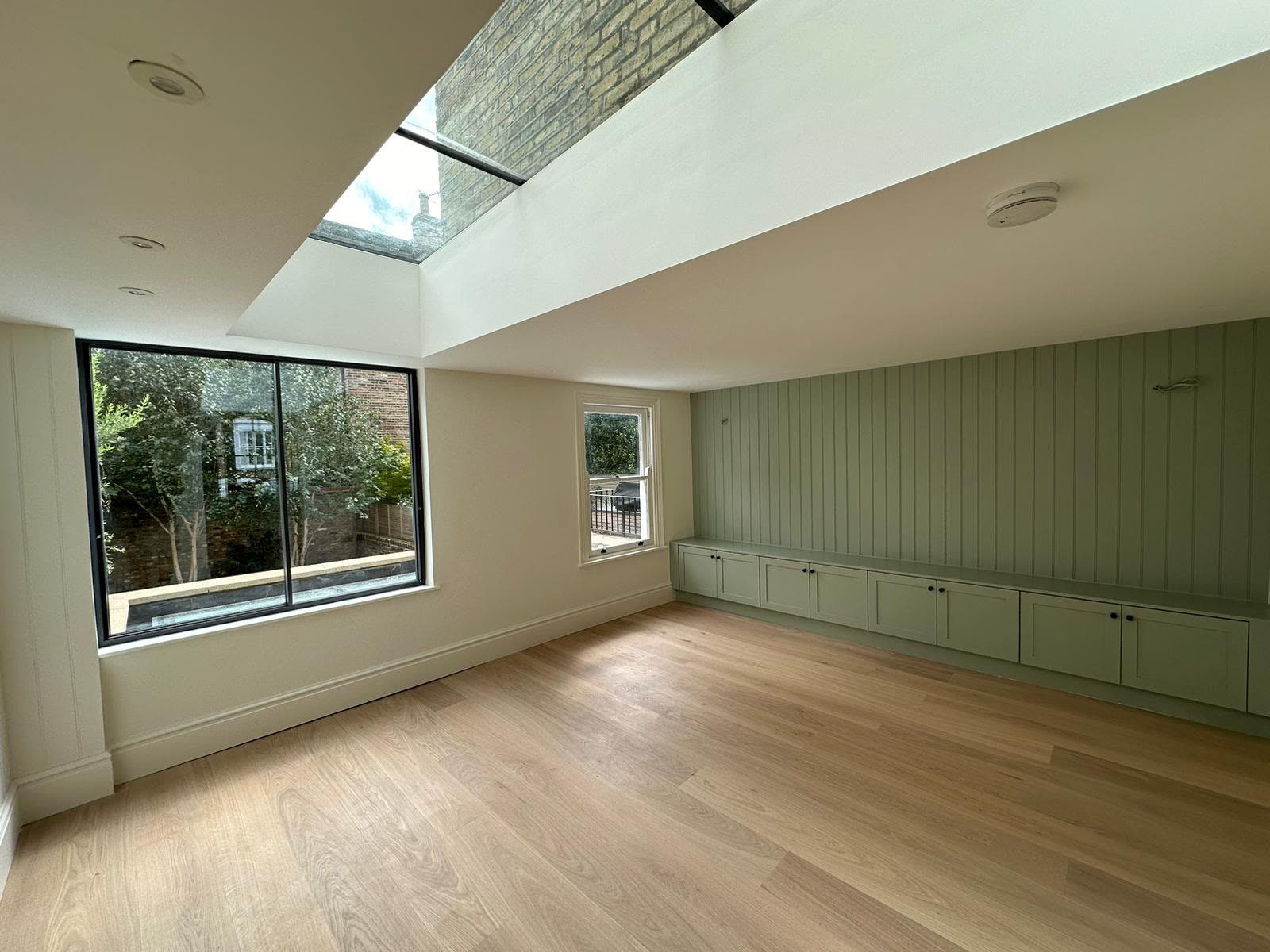 Panelled media wall with cabinets