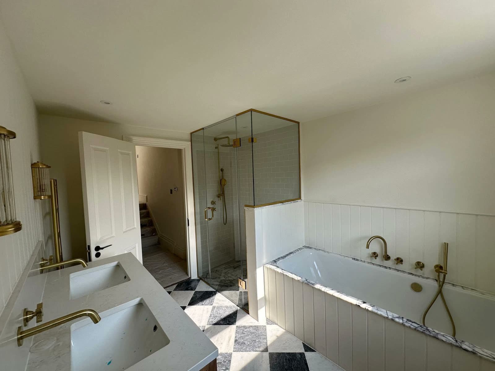 Renovated bathroom with checkerboard marble floor